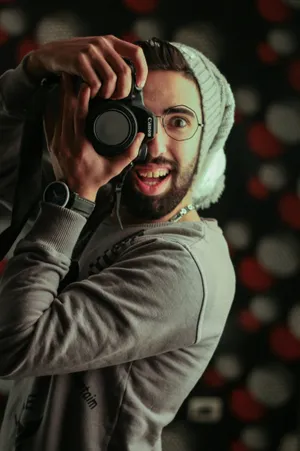 Enthusiastic_ Photographer_in_ Action.jpg Wallpaper