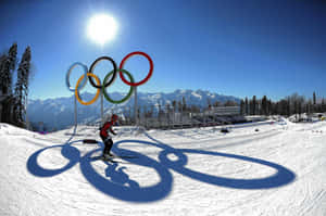 Enthusiastic Snowboarder Catching Air In A Stunning Winter Landscape Wallpaper