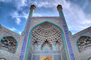 Entry Gate In Shah Mosque Against Blue Sky Wallpaper