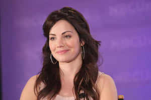 Erica Durance Smiling During Event.jpg Wallpaper