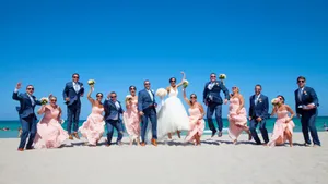 Excited Friends Enjoying A Vibrant Beach Party Wallpaper