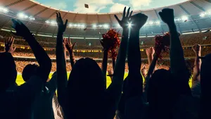 Excited Sports Fans Cheering Stadium Wallpaper