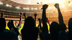 Excited Sports Fans Cheering Stadium Wallpaper