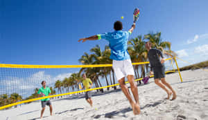 Exciting Beach Tennis Action Wallpaper