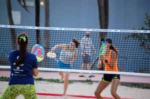 Exciting Beach Tennis Action Wallpaper