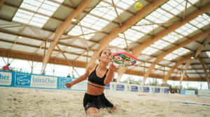 Exciting Beach Tennis Action Wallpaper