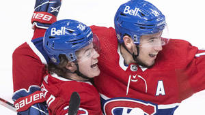 Exciting Celebration Moment Of Cole Caufield And Nick Suzuki Wallpaper