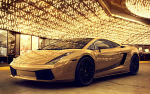 Experience A Touch Of Luxury With This Gold Lamborghini Wallpaper