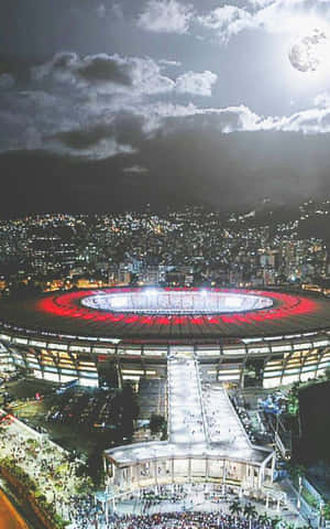 Experience The Excitement Of A Night At The Soccer Stadium Wallpaper