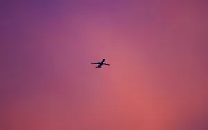 Explore The Wonders Of The Sky In A Pink Plane! Wallpaper