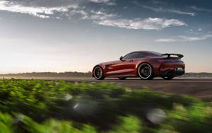 Exquisite Jupiter Red Mercedes Amg Gtr Parked Outdoors Wallpaper