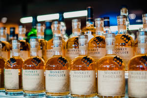 Exquisite Monkey Shoulder Cocktails Arrayed In Rows Wallpaper