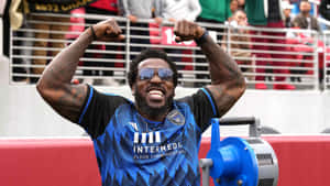 Exuberant Sports Fan Celebration.jpg Wallpaper