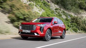 Eye-catching White Haval Suv On A Scenic Mountain Road Wallpaper