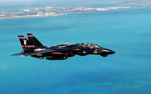 F14_ Jet_ Over_ Coastal_ Waters Wallpaper