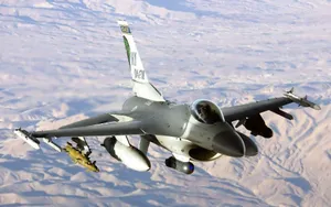 F16_ Fighter_ Jet_ In_ Flight_ Over_ Desert Wallpaper