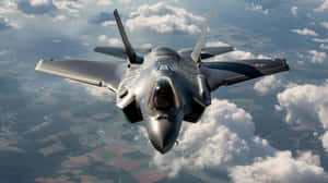 F35 Jet In Flight Over Clouds Wallpaper