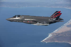 F35 Jet In Flight Over Coastline Wallpaper