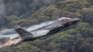 F35 Jet In Flight Over Greenery Wallpaper