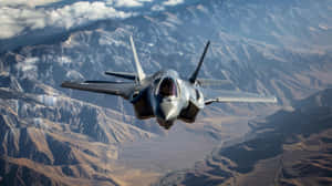 F35 Jet Over Mountainous Terrain Wallpaper