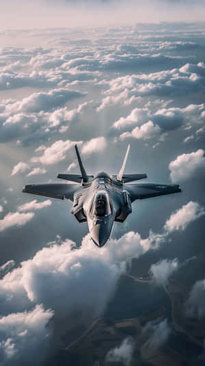 F35 Jet Soaring Above Clouds Wallpaper