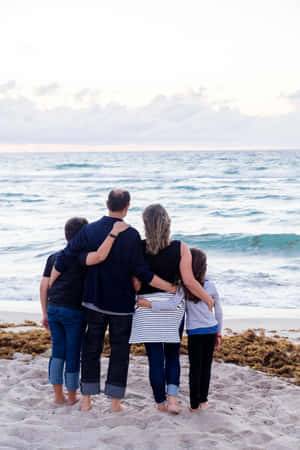 Family_ Beach_ Sunset_ Embrace Wallpaper