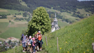 Family Enjoying A Scenic Hiking Adventure Wallpaper