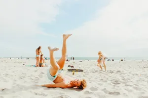 Family Having Fun At The Beach During Summer Vacation Wallpaper