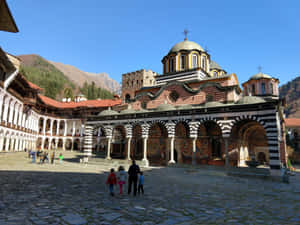 Family Outside The Rila Monastery Wallpaper