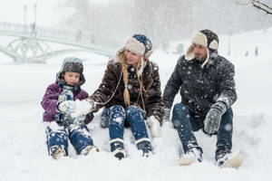 Family Playing With Snow Wallpaper