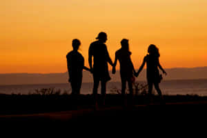 Family Silhouette Sunset Walk Wallpaper