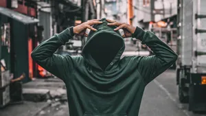 Fashion-forward Green Hoodie On City Streets Wallpaper