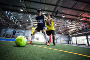 Fast-paced Indoor Soccer Action Wallpaper
