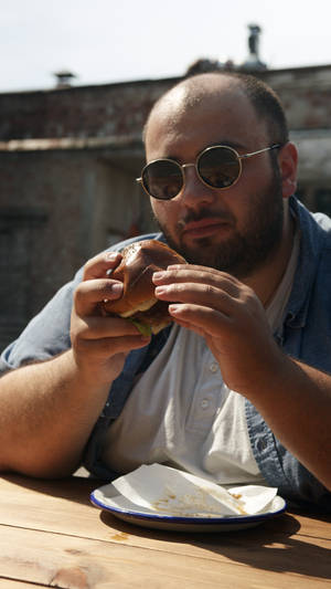 Fat Person Eating Burger Wallpaper