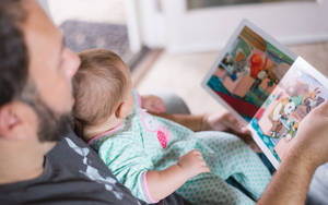 Father And Child Reading Story Book Wallpaper