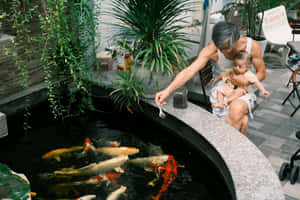 Father Child Koi Pond Moment.jpg Wallpaper