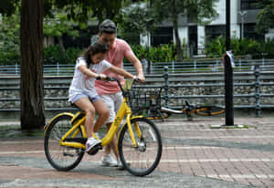 Father Daughter Bike Lesson.jpg Wallpaper