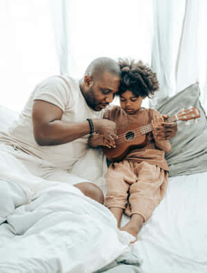 Father Daughter Ukulele Lesson Wallpaper