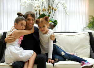 Father Embracing Daughters Living Room Wallpaper