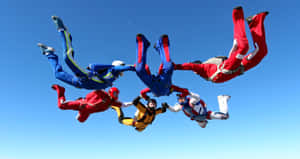 Fearless Adventurer Standing At The Edge Of A Cliff Wallpaper