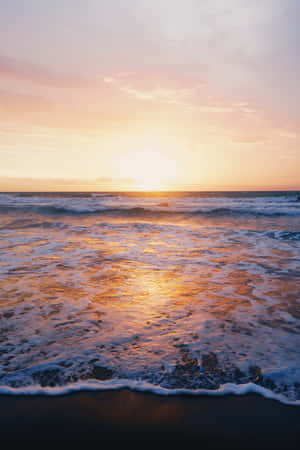 Feel The Energy Of The Setting Sun On A Beautiful Beach. Wallpaper