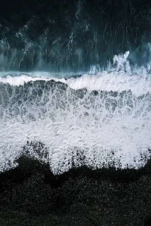 Feel The Warmth Of The Sun On Beautiful Black Sand Beach. Wallpaper