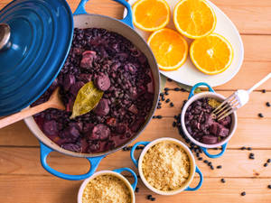 Feijoada - Traditional Brazilian Black Bean Stew Served In A Blue Casserole Wallpaper