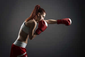 Female Boxer Throwing Punch Wallpaper