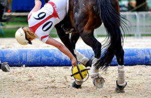 Female Equestrian Falling During Her Match Wallpaper