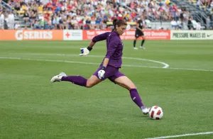 Female_ Goalkeeper_ Kicking_ Soccer_ Ball Wallpaper