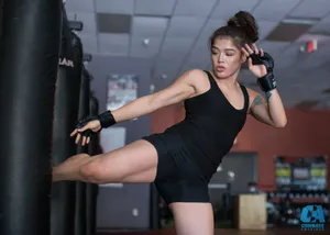 Female M M A Fighter Training Kick Wallpaper