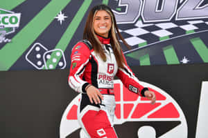 Female Racecar Driver Smilingat Trackside Wallpaper