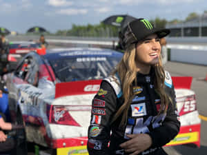 Female Racecar Driverat Track Wallpaper