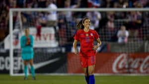 Female Soccer Player Smiling During Match Wallpaper